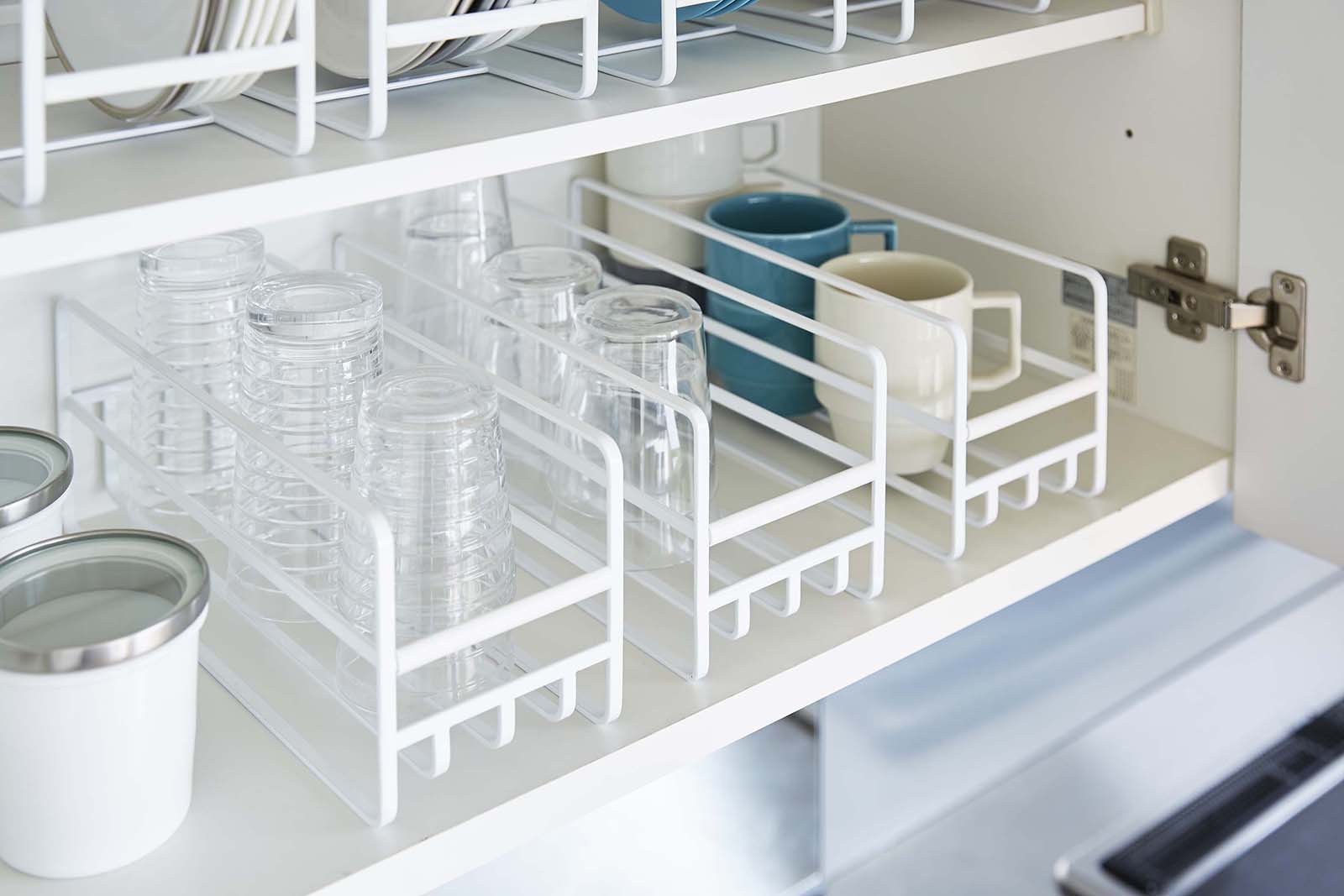 Three of Yamazaki Home Glass and Mug Cabinet Organizer in a kitchen cabinet holding cups. 