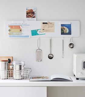 Yamazaki white Magnetic Wall Panel with kitchen utensils hanging from hooks view 2