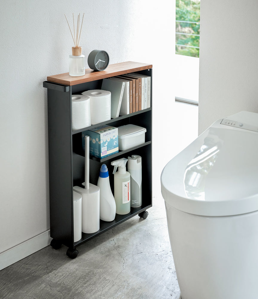 View 10 - Black Rolling Storage Cart holding bathroom supplies in bathroom by Yamazaki Home.