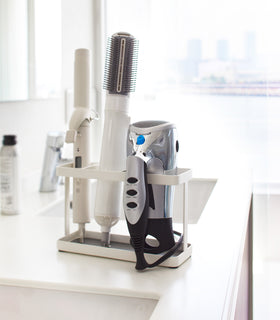 White Hair Tool and Styling Accessory Organizer holding hot tools on bathroom counter by Yamazaki Home. view 3