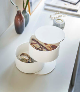 Front view of white Stacked Jewelry Box holding glasses, a watch, and jewelry on the countertop by Yamazaki Home. view 2