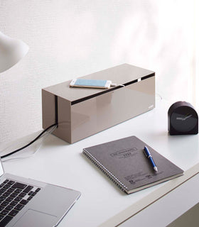 Taupe Cable Management Box holding wires on office desk by Yamazaki Home. view 12