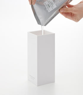 Pouring refill into White Yamazaki Home square shampoo dispenser view 5