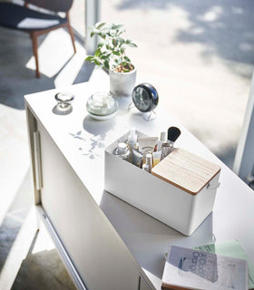 Closed white Makeup Organizer holding makeup on countertop by Yamazaki Home. view 3