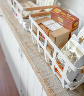 Close up aerial view of white Storage Basket holding food items by Yamazaki Home. view 9