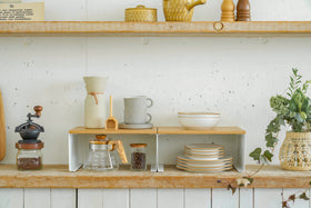 Black Dish Rack holding dinnerware next to kitchen sink by Yamazaki Home. view 6