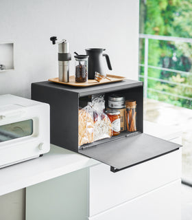 Black Bread Box holding bread and jams on countertop by Yamazaki Home. view 8