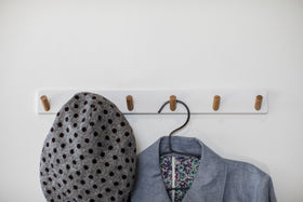 Front view of white Wall-Mounted Coat Hanger holding hat and jacket by Yamazaki Home. view 4