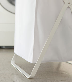 Close up bottom view of white Laundry Hamper Storage Organizer by Yamazaki Home. view 5