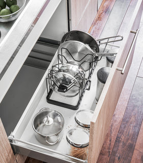 Aerial view of black Adjustable Pot Lid Organizer in kitchen drawer. view 17