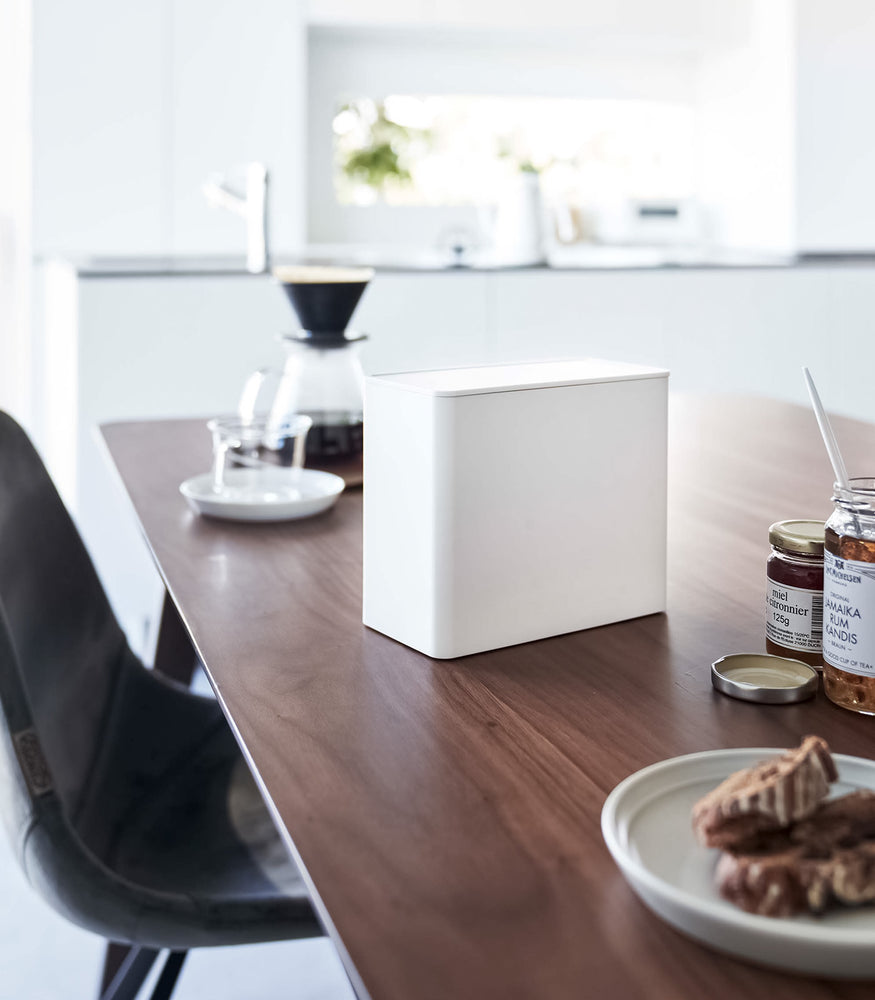 View 8 - White Yamazaki Home kitchen storage box with a closed lid on dining table