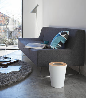 Side view of white Pedal Trash Can in living room by Yamazaki Home. view 11