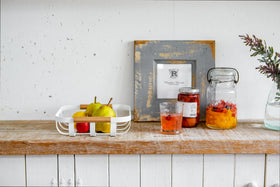 Front view of white Fruit Bowl holding fruit on shelf by Yamazaki Home. view 5