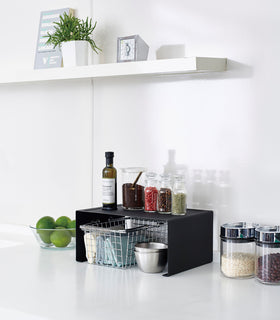 Back Stackable Countertop Shelf holding spices and oil in kitchen by Yamazaki Home. view 16