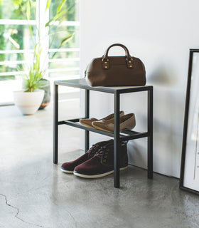 Side view of Black Shoe Organizer holding shoes and a purse by Yamazaki Home. view 12