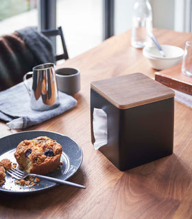 Black toilet paper holder on tabletop by Yamazaki Home. view 8