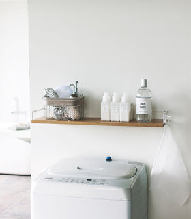 Wall-Mounted Shelf holding cleaning items in laundry room by Yamazaki Home. view 2