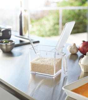 White Pantry Organizer open holding rice on kitchen countertop by Yamazaki Home. view 13