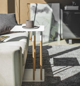 Side view of white C Side Table holding coffee cup in living room by Yamazaki Home. view 3