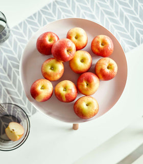 Top-down view of white Yamazaki Countertop Pedestal Tray with apples on top view 5