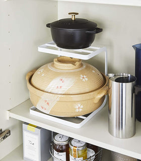 White Pot Holder holding pots in kitchen cabinet by Yamazaki Home. view 6