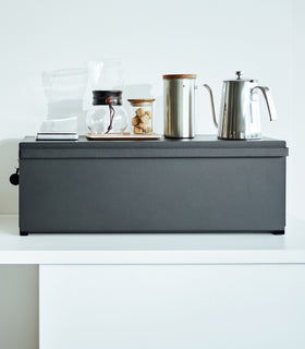 Frontal view of black Yamazaki Home Bread Box - Wide with coffee equipment on top view 11