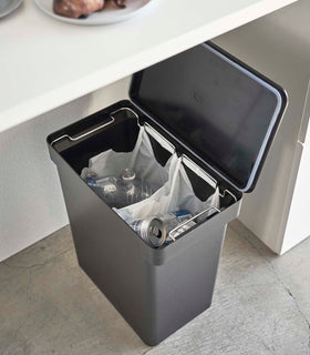 Aerial view of black Rolling Trash Can holding recyclables in kitchen by Yamazaki Home. view 13