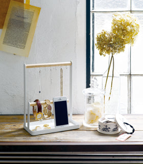 White Undershelf Organizer holding spices and dish towel by Yamazaki Home. view 3