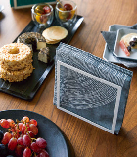 Aerial view of white Napkin Holder holding napkins on dining table by Yamazaki Home. view 3