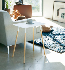 White Side Table holding coffee cup in living room by Yamazaki Home. view 2