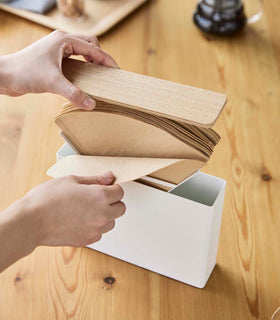 Aerial view of person accessing coffee filters from the Coffee Filter Case by Yamazaki Home. view 7