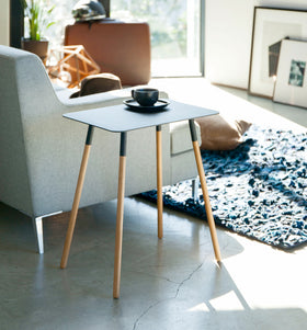 Black Side Table holding coffee cup in living room by Yamazaki Home. view 7