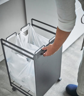 Black Rolling Trash Sorter holding plastic bags by Yamazaki Home. view 8