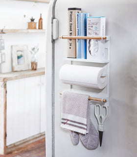 White Magnetic Organizer on kitchen fridge holding kitchen and cleaning equipment by Yamazaki Home. view 2