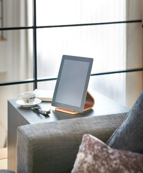 Ash Tablet Stand holding tablet on end table in living room by Yamazaki Home. view 8