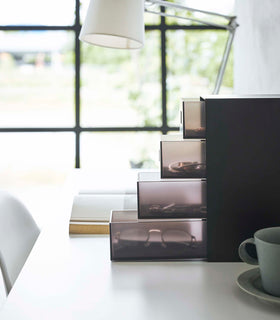 Side view of black Yamazaki Home Storage Tower with Drawers filled with accessories view 13