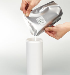 Front view of white Shampoo Dispenser getting filled with shampoo on white background by Yamazaki Home. view 8