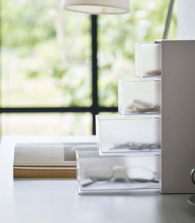 Side view of white Yamazaki Home Storage Tower with Drawers filled with accessories view 5