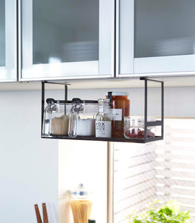 Black Under Shelf Spice Rack displaying spices in kitchen by Yamazaki Home. view 6