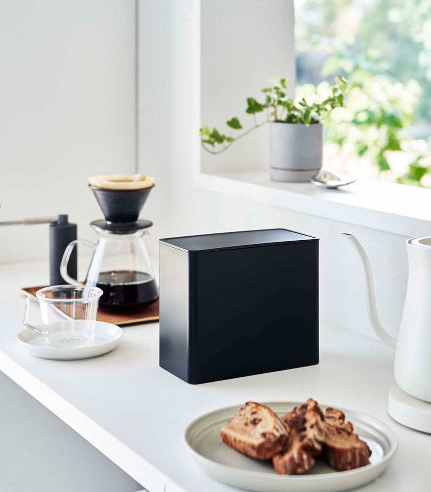 View 12 - Black Yamazaki Home kitchen storage box with a closed lid on countertop