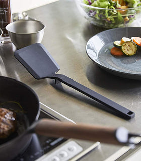 Black Floating Spatula on kitchen counter by Yamazaki Home. view 8