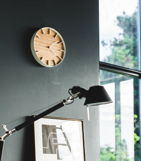 Angled side view of white Wall Clock in bedroom by Yamazaki Home. view 3