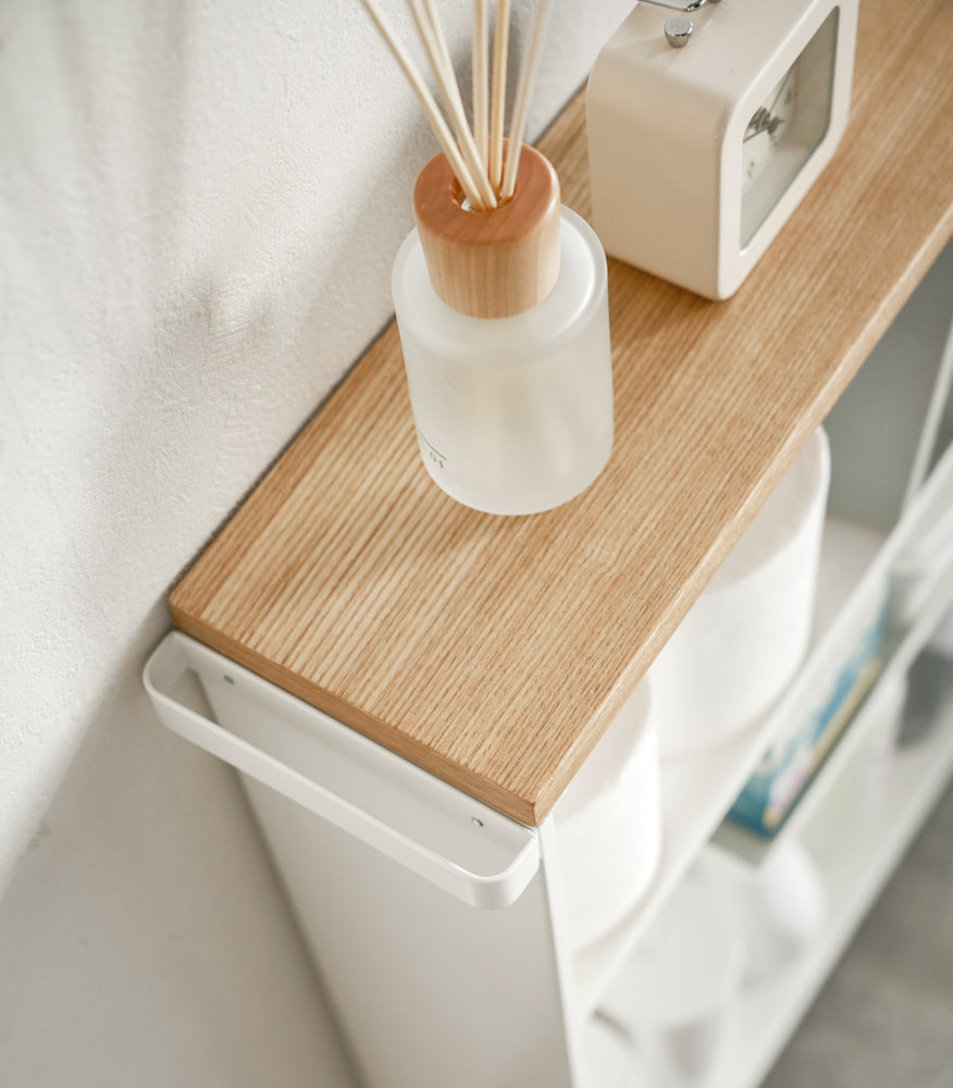 View 6 - Aerial view of white Rolling Storage Cart holding clock and toilet paper by Yamazaki Home.