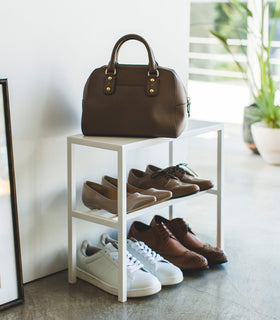 Side view of white Shoe Organizer holding shoes and purse by Yamazaki Home. view 5