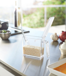 White Undershelf Organizer hanging from cabinet holding storage items and towels by Yamazaki Home. view 3