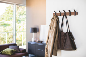 Walnut Wall-Mounted Coat Hanger displaying bag and jacket by Yamazaki Home. view 8