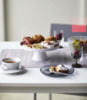 Front view of white Stackable Serving Stand holding desserts on table by Yamazaki Home. view 3