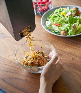 Black Storage Container pouring cereal into bowl by Yamazaki Home. view 12