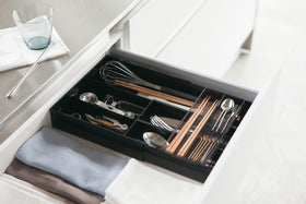 Black Expandable Drawer Organizer holding silverware in kitchen by Yamazaki Home. view 36