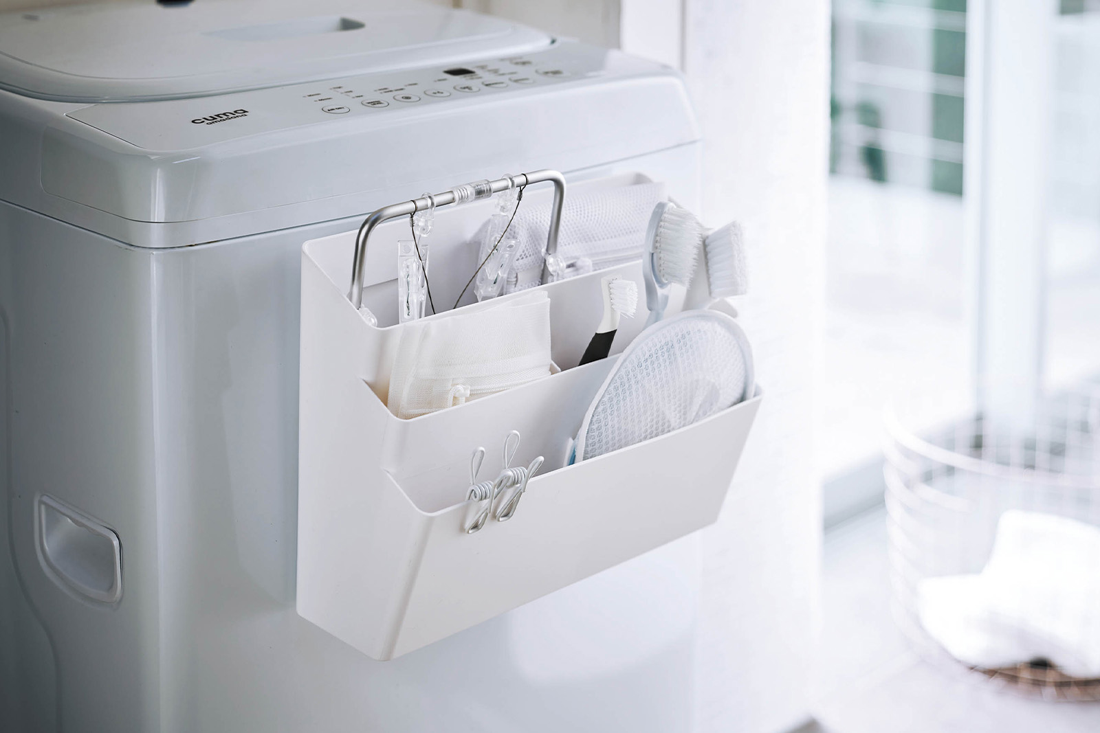 Yamazaki Home white Magnetic Storage Caddy holding bathroom essentials. 